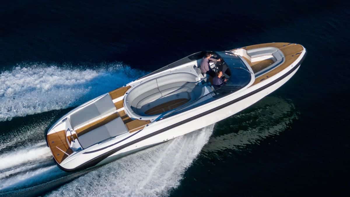 A rigid inflatable boat driving past a superyacht