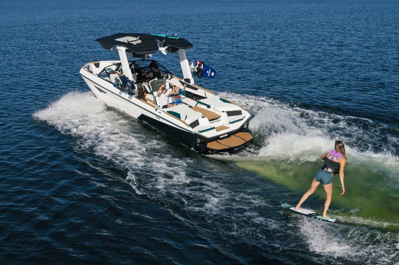 Woman wakeboarding on a Nautique S25