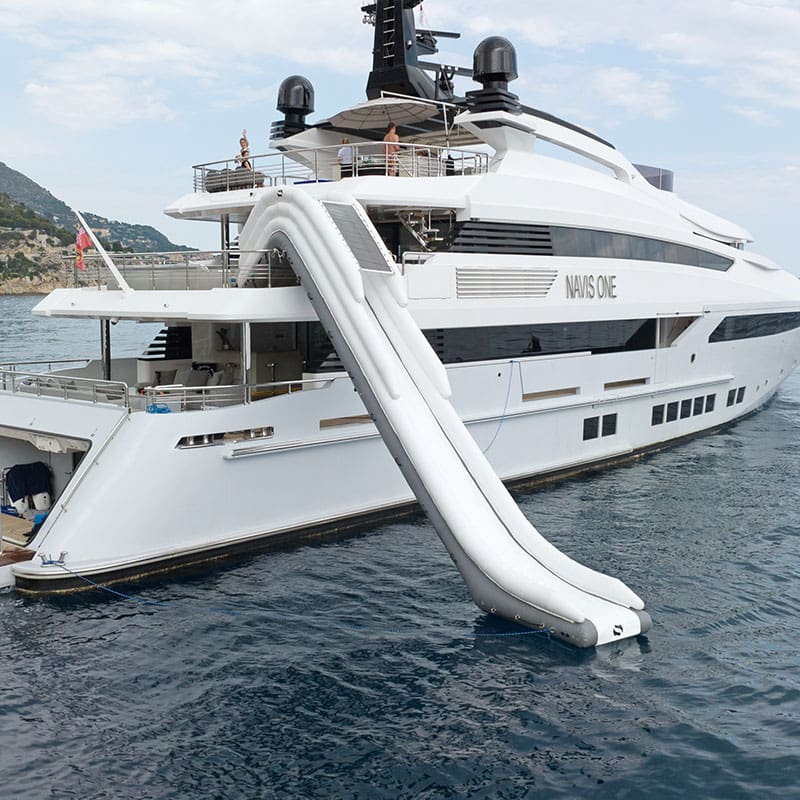A large white yacht with an inflatable slide