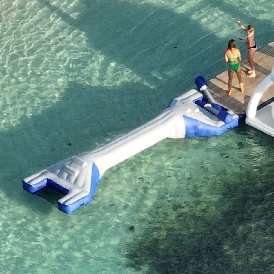 An inflatable balance beam set up in shallow water close to the beach