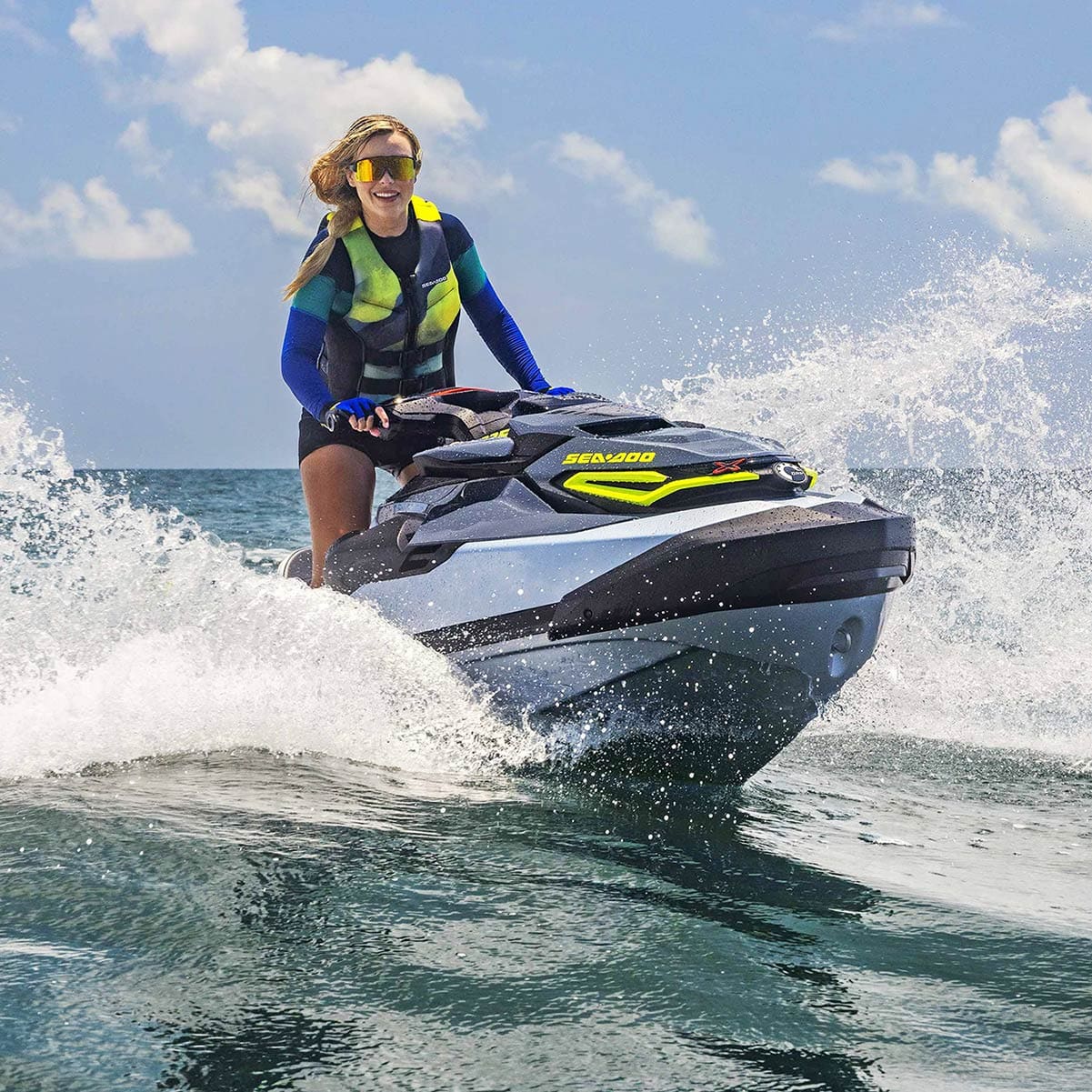 A small submarine being deployed into the water from a yacht