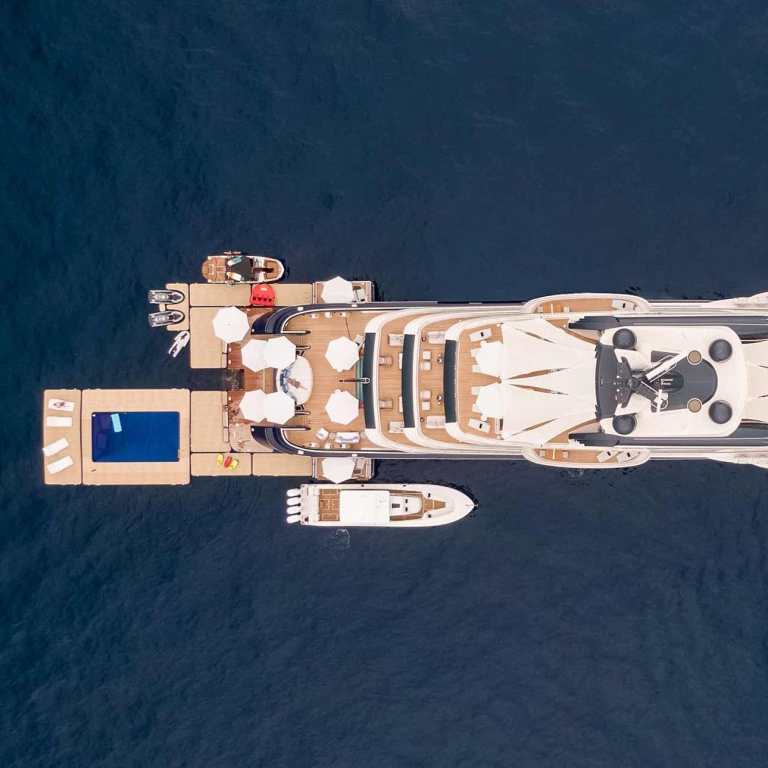 A birds eye view of a superyacht with a large area of inflatables on the stern