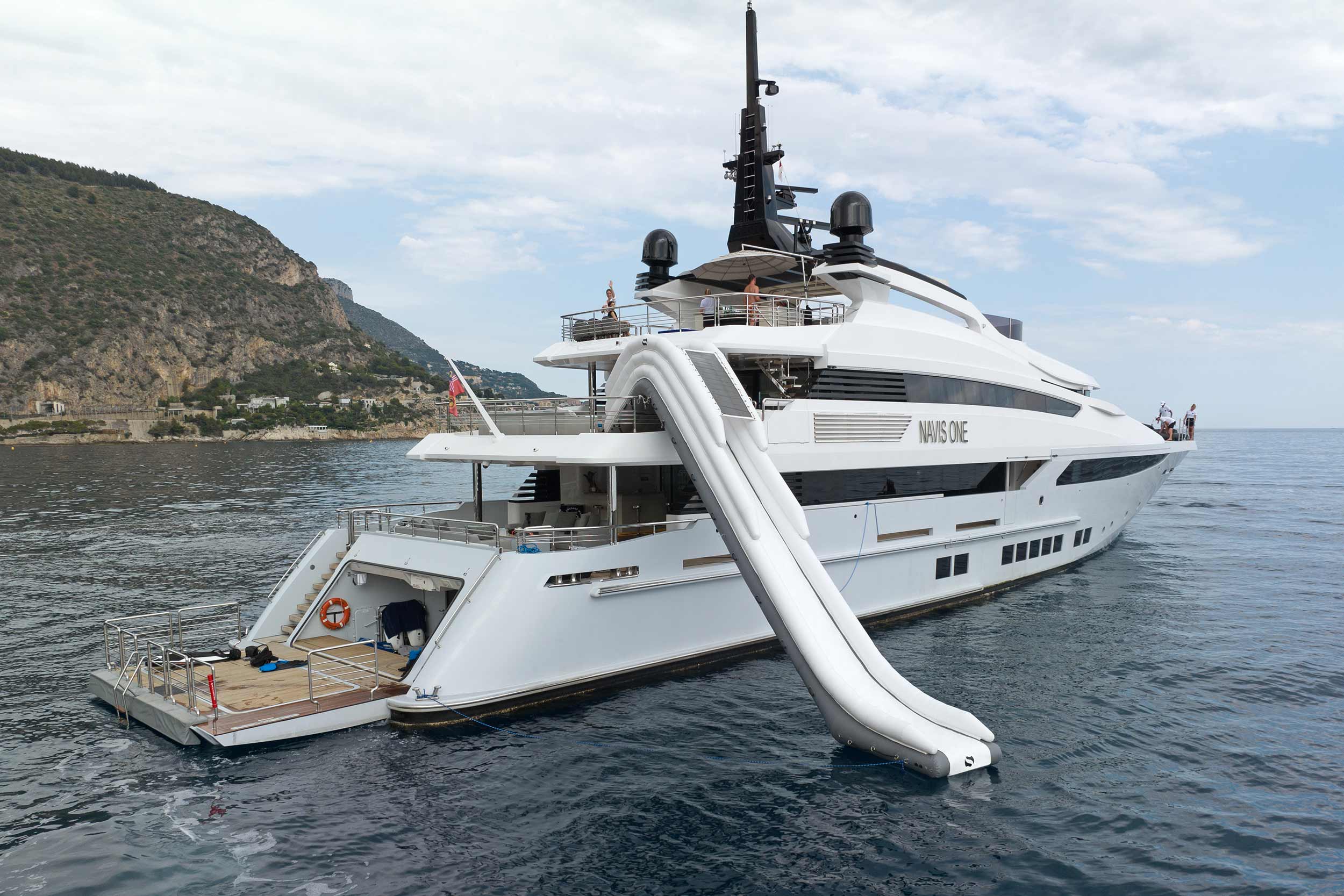 Inflatable platforms with water toys on attached to the stern of a large yacht