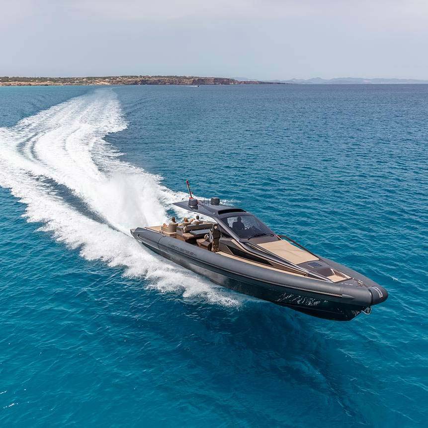 A rigid inflatable boat driving past a superyacht