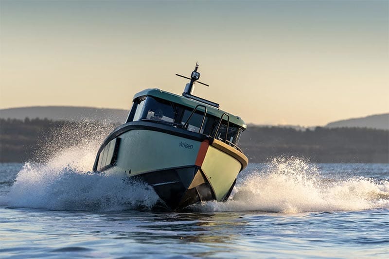 A rigid inflatable boat driving past a superyacht