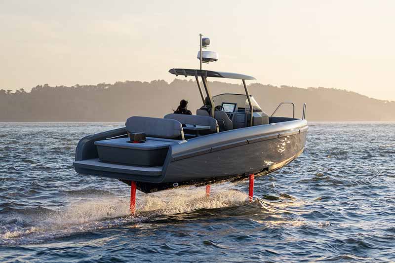 A rigid inflatable boat driving past a superyacht
