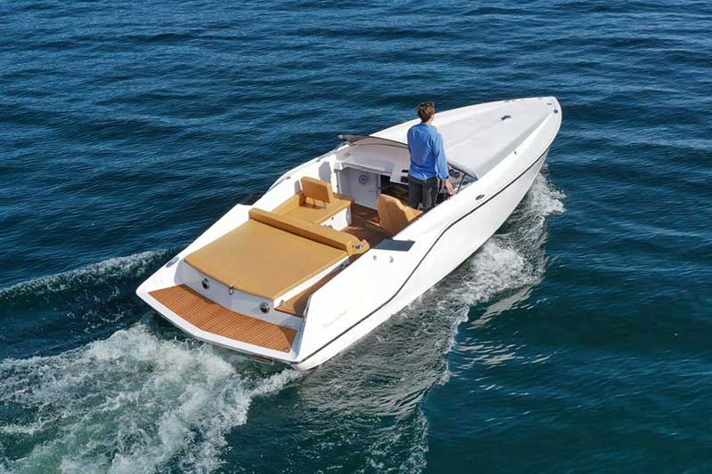 A rigid inflatable boat driving past a superyacht