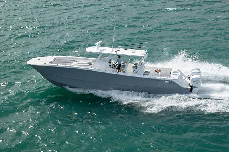 A rigid inflatable boat driving past a superyacht