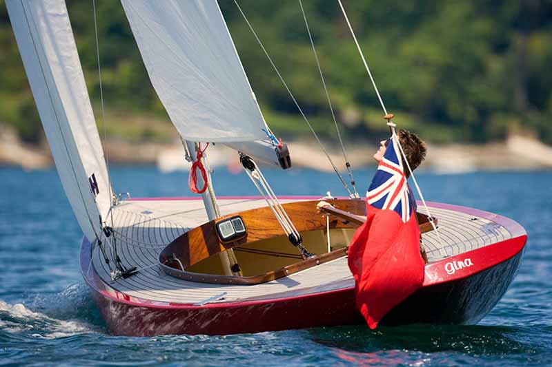 A rigid inflatable boat driving past a superyacht