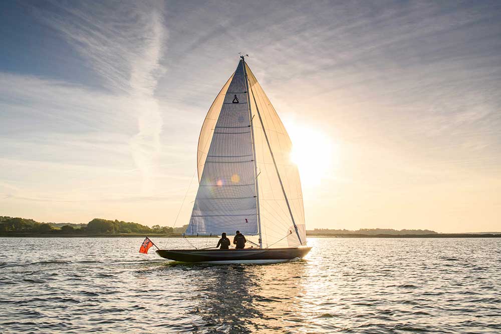 A white boat with two motors, ideal as tenders for yachts, glides gracefully in the water.