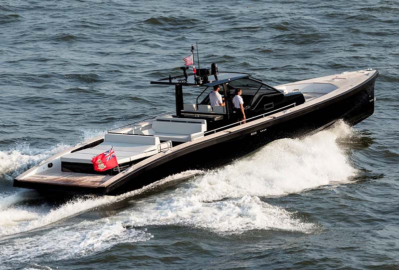 A rigid inflatable boat driving past a superyacht