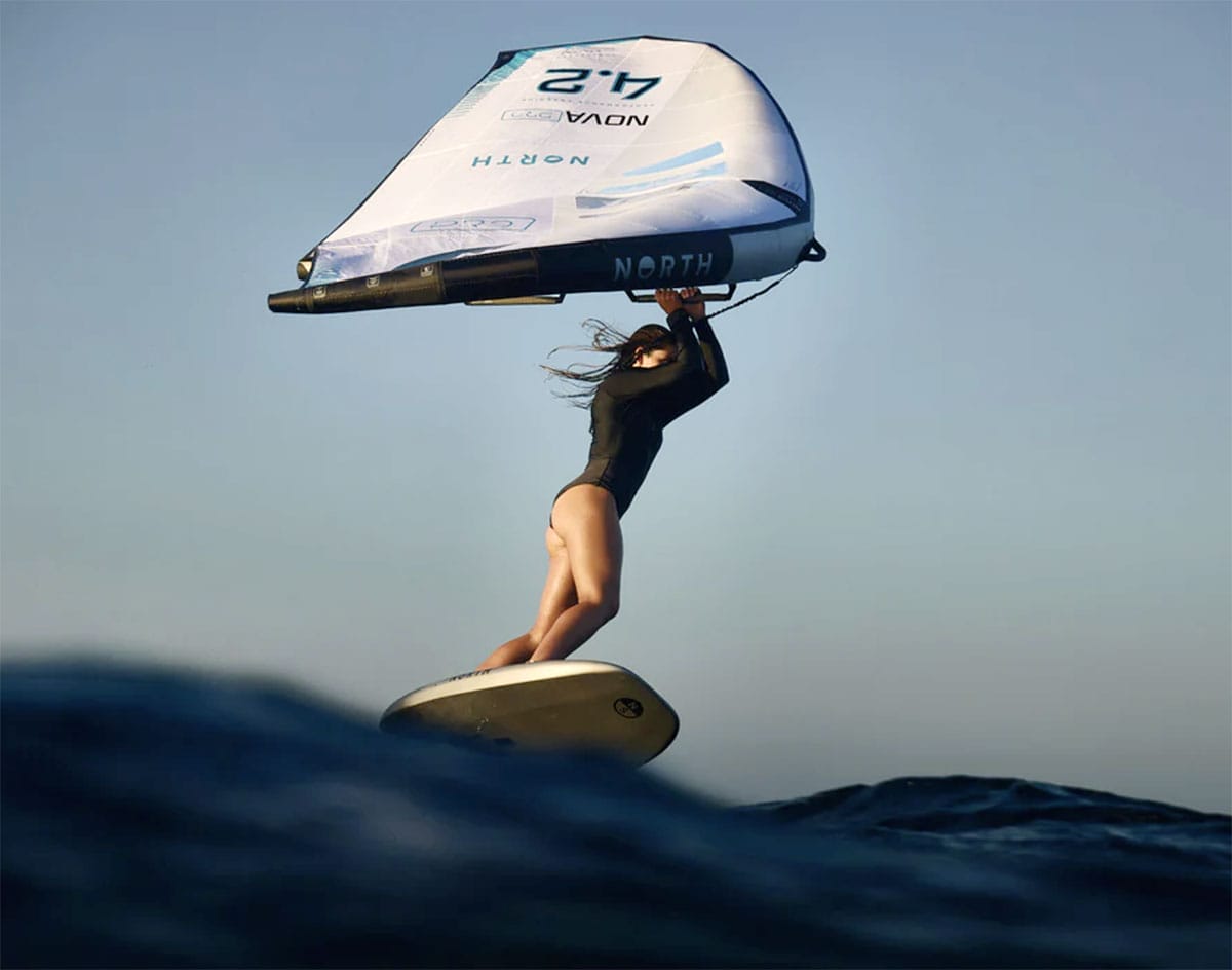 A small submarine being deployed into the water from a yacht