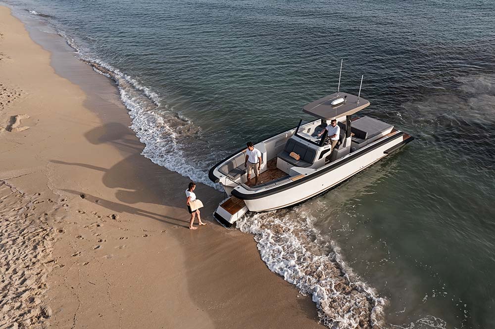A rigid inflatable boat driving past a superyacht