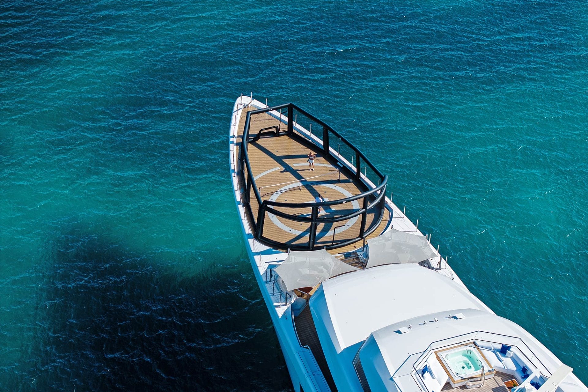 Inflatable platforms with water toys on attached to the stern of a large yacht