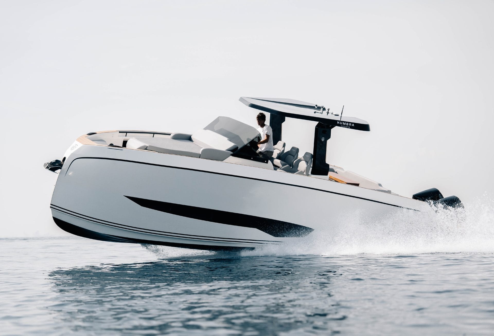 A rigid inflatable boat driving past a superyacht