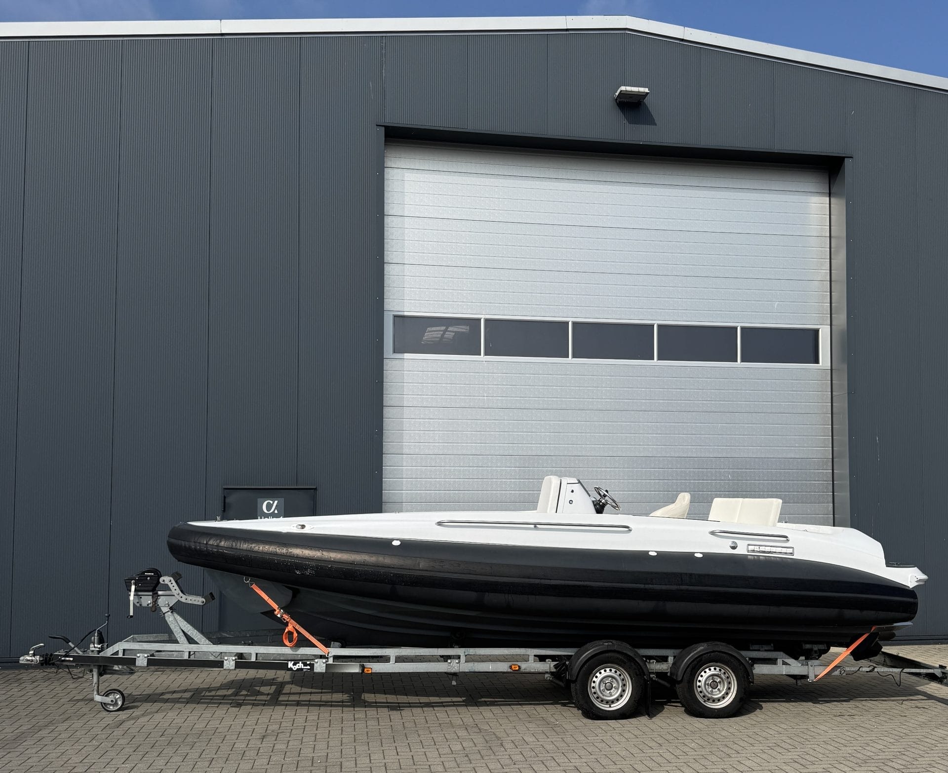 side view of tender in front of garage